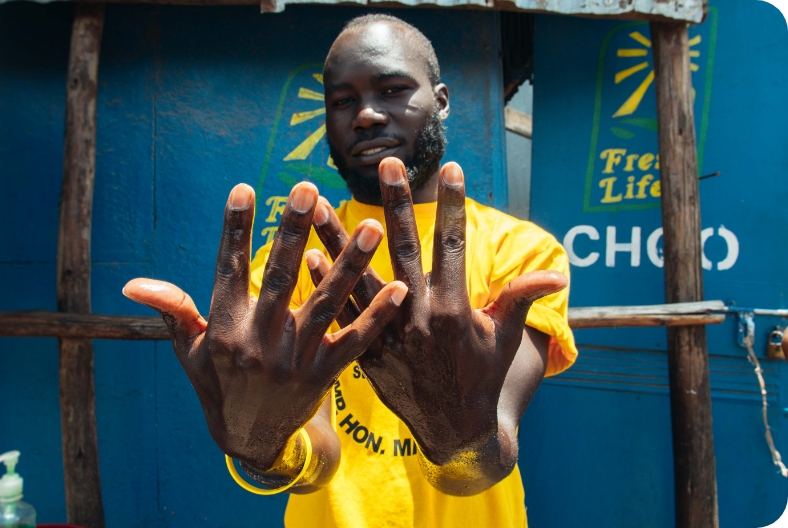 Gentleman showing his hands after washing them on Fresh life toilet tap